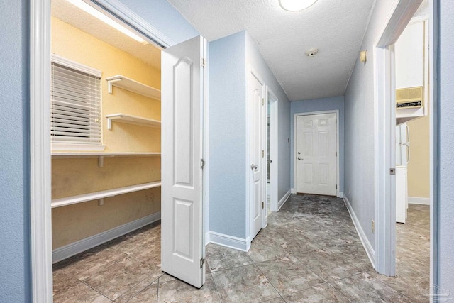 hallway featuring a textured ceiling