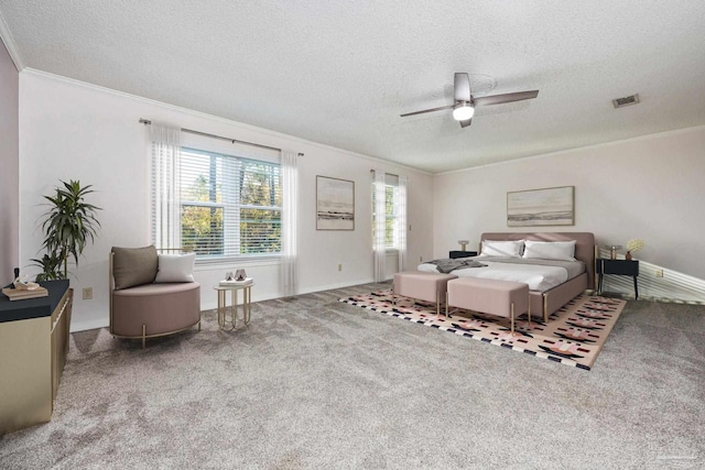 carpeted bedroom with ceiling fan, a textured ceiling, and ornamental molding