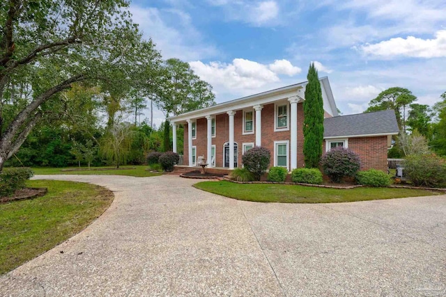 greek revival inspired property with a front lawn