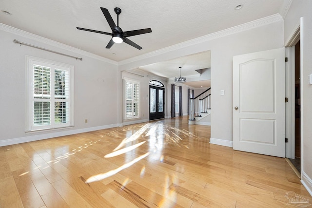 spare room featuring ceiling fan, ornamental molding, and light hardwood / wood-style flooring