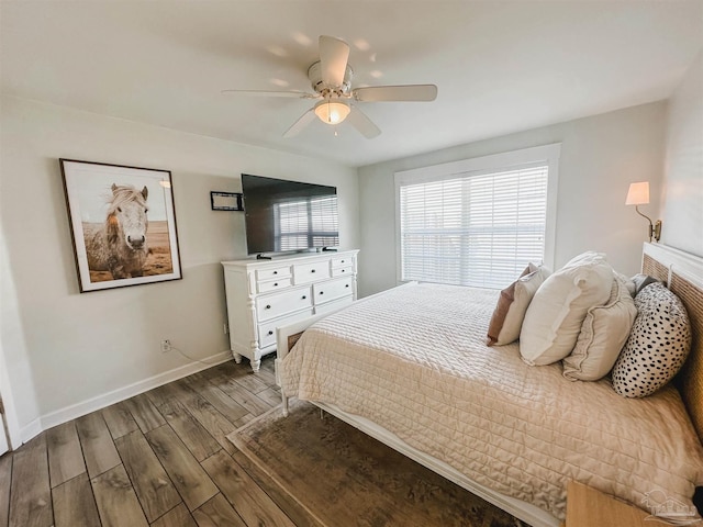 bedroom featuring a ceiling fan, baseboards, and wood finished floors