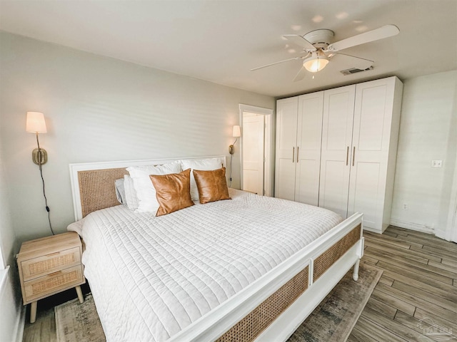 bedroom featuring ceiling fan, light wood finished floors, a closet, and visible vents