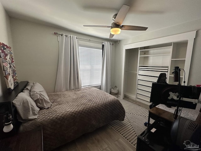 bedroom with a ceiling fan, a closet, and wood finished floors