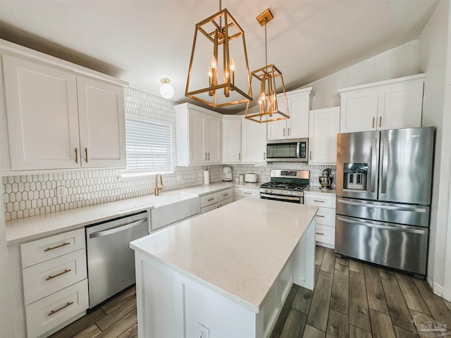 kitchen featuring tasteful backsplash, dark wood-type flooring, a center island, stainless steel appliances, and pendant lighting