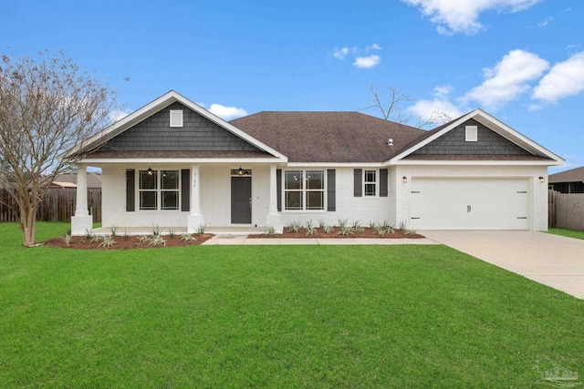 view of front of home with a porch, a garage, and a front lawn