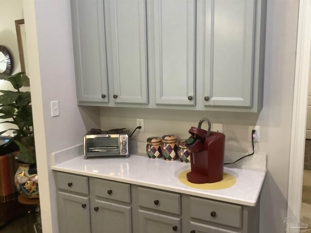 washroom featuring independent washer and dryer, light hardwood / wood-style flooring, and cabinets