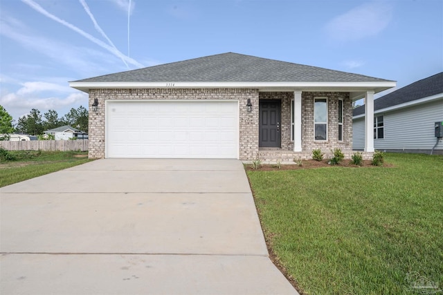 view of front of home with a front yard and a garage