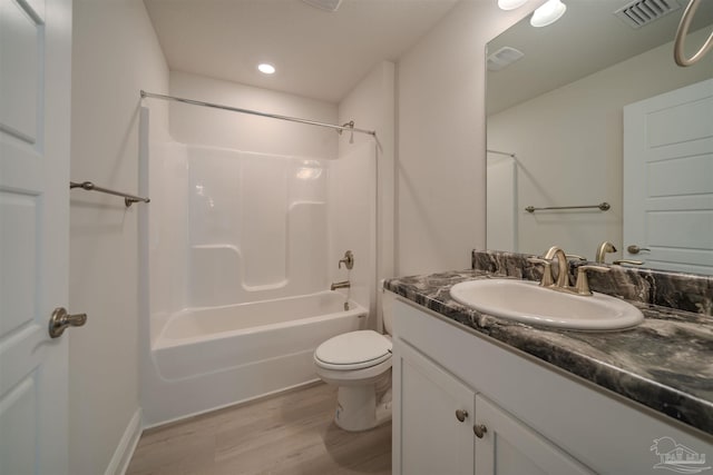 full bathroom featuring shower / bath combination, vanity, wood-type flooring, and toilet