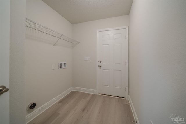 laundry room featuring hookup for a washing machine and light hardwood / wood-style flooring