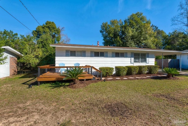 back of house with a lawn and a deck