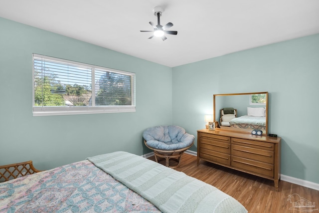 bedroom with wood-type flooring and ceiling fan