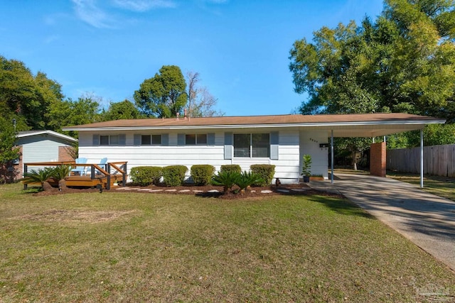 single story home featuring a front yard, a deck, and a carport