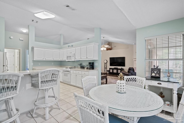 10738 Magnolia Ln, Lillian, AL 36549 - dining room with light tile patterned floors, visible vents, lofted ceiling, and ceiling fan