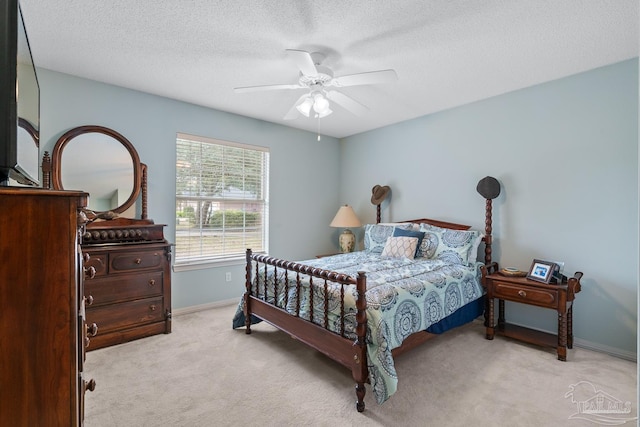 10738 Magnolia Ln, Lillian, AL 36549 - bedroom featuring baseboards, light carpet, a textured ceiling, and a ceiling fan
