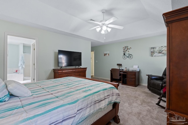 10738 Magnolia Ln, Lillian, AL 36549 - bedroom featuring baseboards, ensuite bath, a tray ceiling, ceiling fan, and light colored carpet