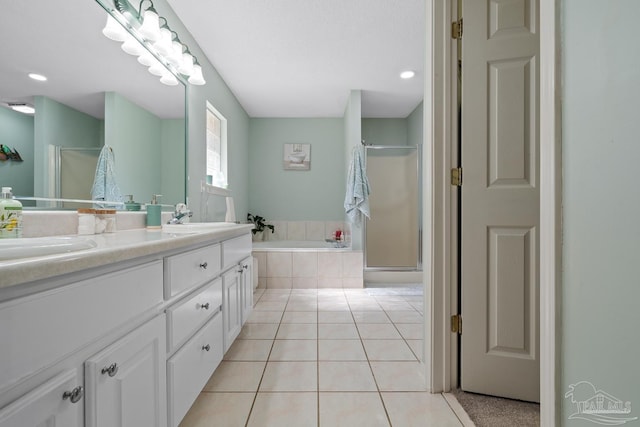 10738 Magnolia Ln, Lillian, AL 36549 - full bathroom with double vanity, a sink, tile patterned flooring, a shower stall, and a bath