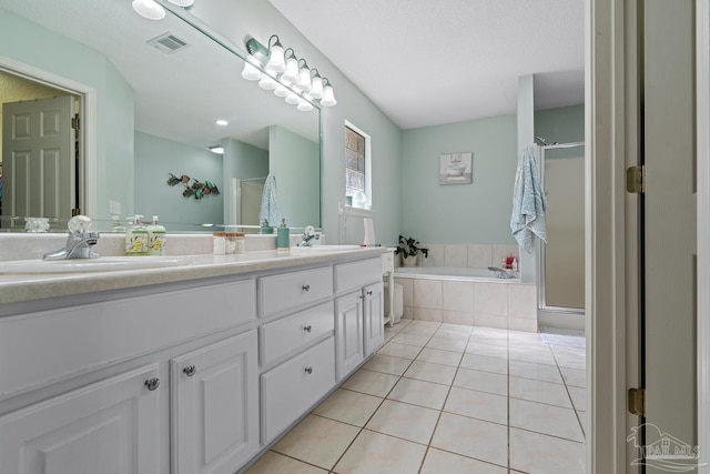 10738 Magnolia Ln, Lillian, AL 36549 - full bath featuring tile patterned flooring, a stall shower, a garden tub, and a sink