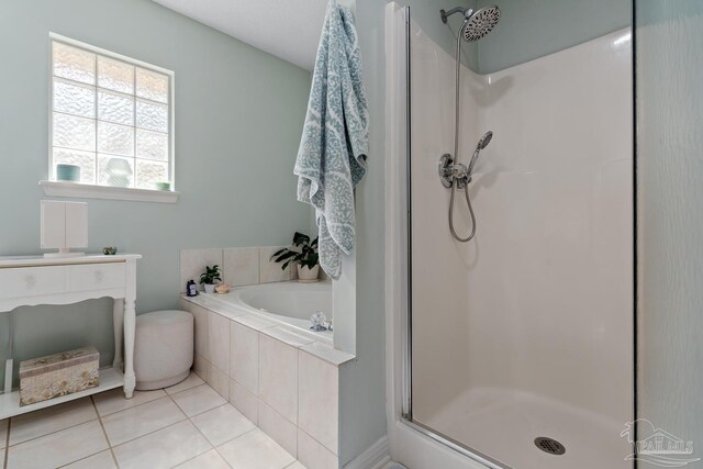 10738 Magnolia Ln, Lillian, AL 36549 - bathroom with tile patterned floors, a stall shower, and a bath