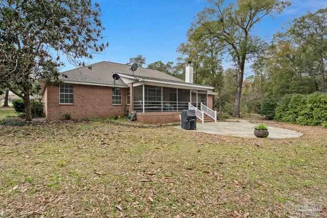 10738 Magnolia Ln, Lillian, AL 36549 - back of property featuring a patio area, a lawn, a chimney, and a sunroom