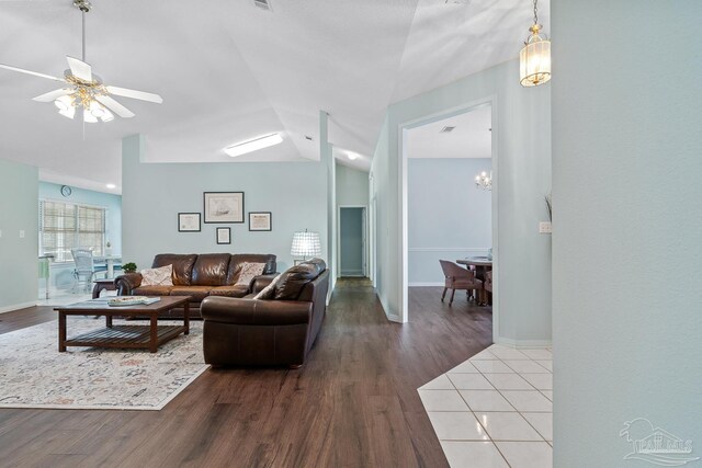 10738 Magnolia Ln, Lillian, AL 36549 - living room featuring ceiling fan, baseboards, wood finished floors, and vaulted ceiling