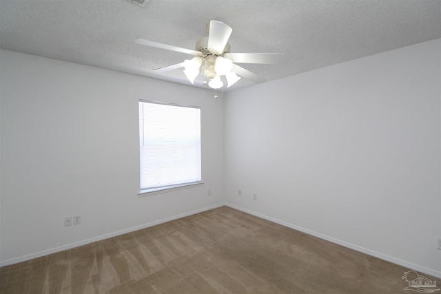 carpeted empty room featuring ceiling fan and a textured ceiling