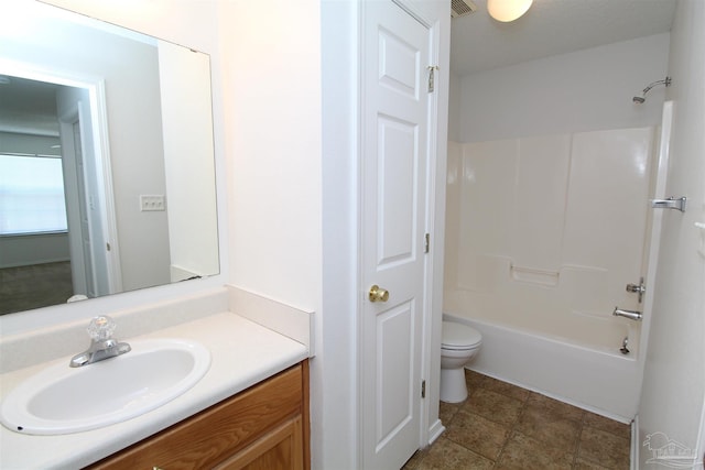 full bathroom featuring tile patterned floors, toilet, washtub / shower combination, and vanity