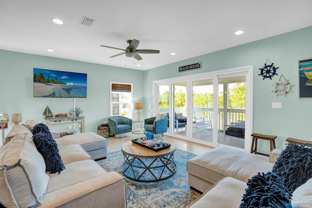 living room featuring tile patterned floors and ceiling fan