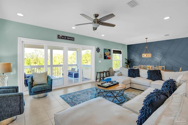 living room featuring a wealth of natural light, ceiling fan, and light tile patterned floors