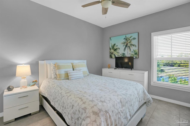 tiled bedroom featuring multiple windows and ceiling fan