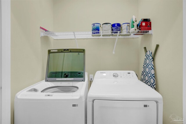 laundry area with independent washer and dryer