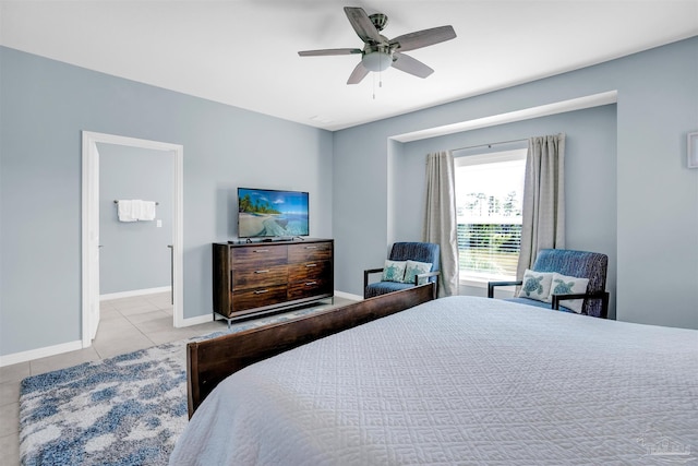 tiled bedroom with connected bathroom and ceiling fan