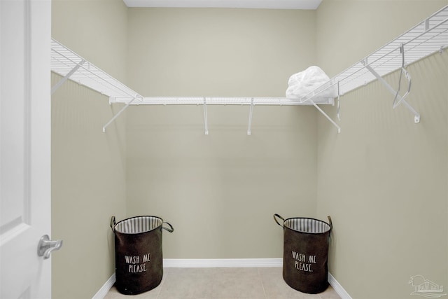 walk in closet featuring light tile patterned flooring