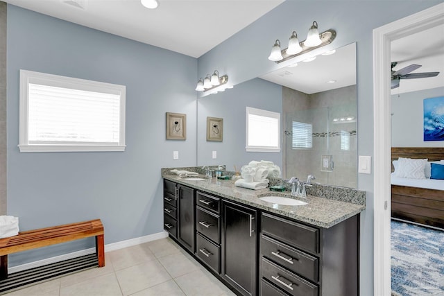 bathroom with vanity, ceiling fan, a tile shower, and tile patterned floors