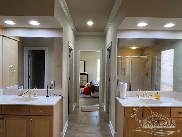 bathroom featuring crown molding, vanity, a shower with door, and tile patterned flooring