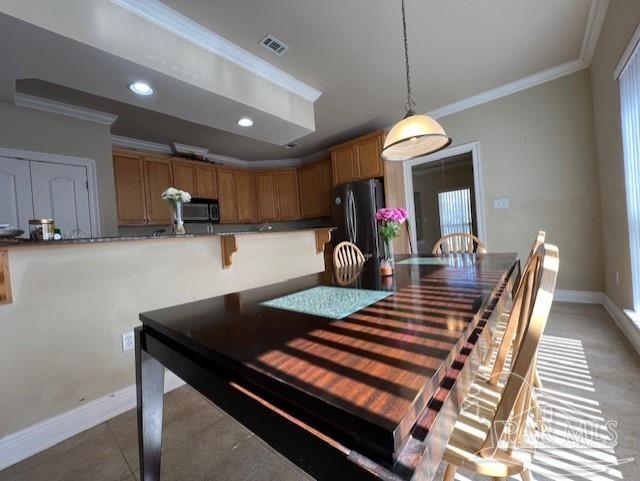 dining space with crown molding