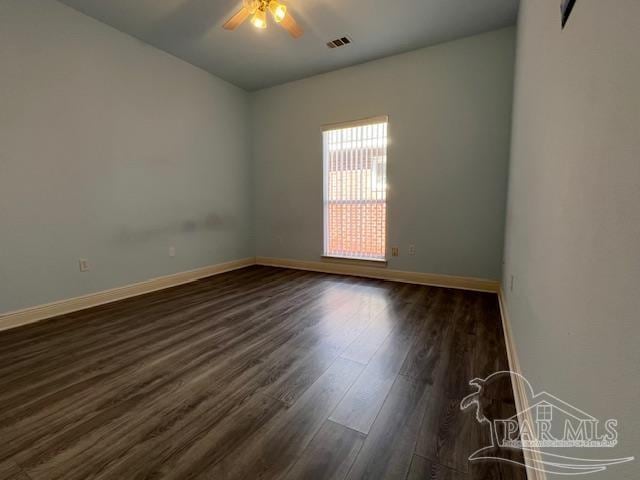 spare room featuring dark hardwood / wood-style flooring and ceiling fan