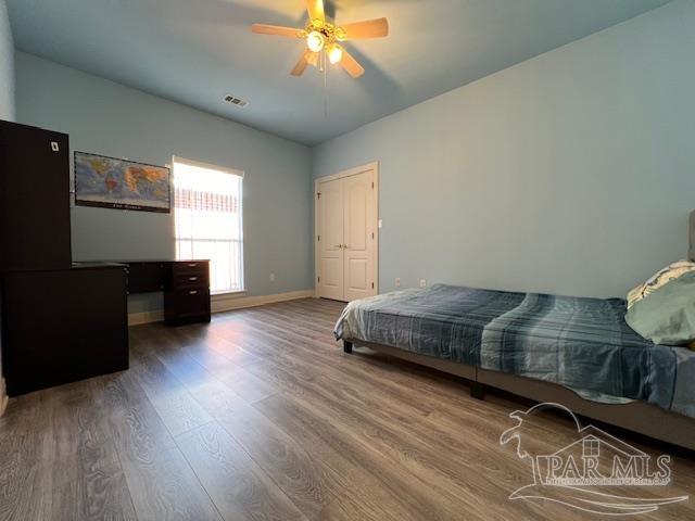 bedroom with ceiling fan and hardwood / wood-style floors