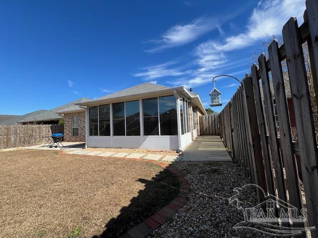 back of house featuring a patio and a sunroom