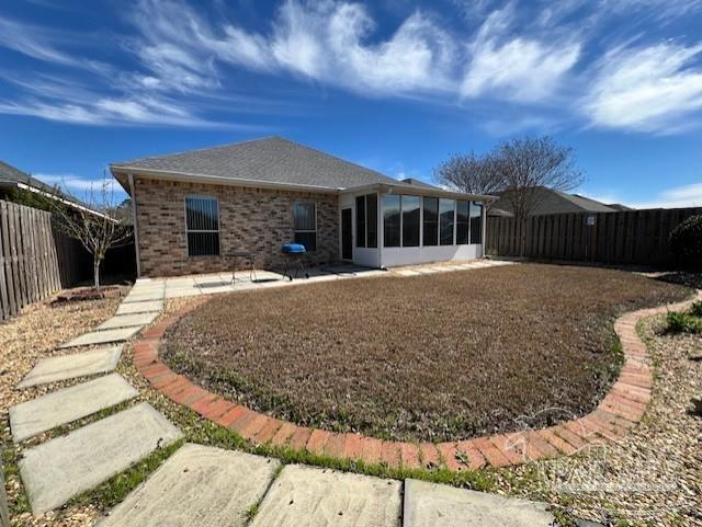 back of house with a patio and a sunroom