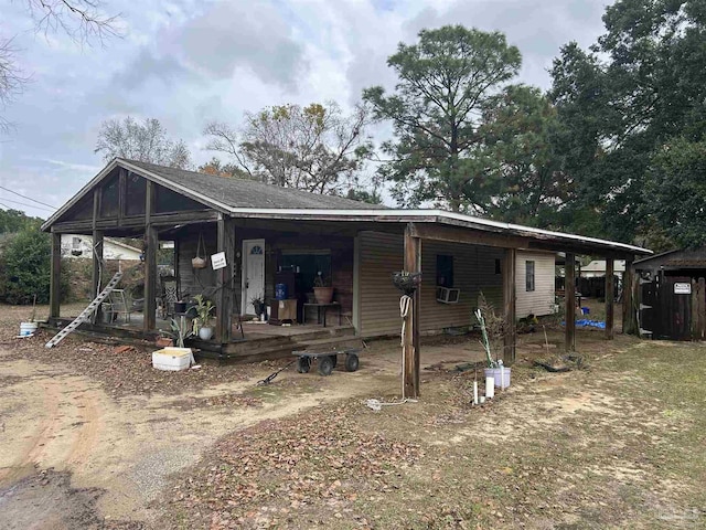 back of property with covered porch