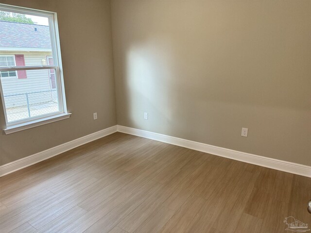 empty room with ceiling fan and light hardwood / wood-style floors