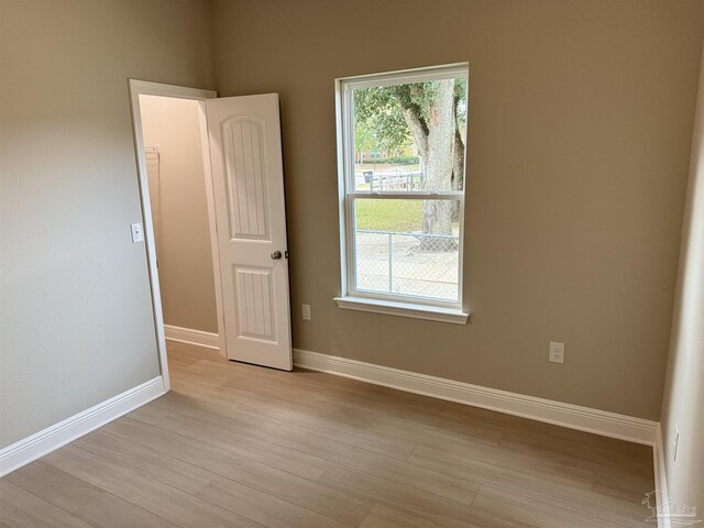 bathroom with hardwood / wood-style flooring and a bath