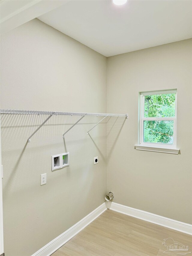 bathroom with hardwood / wood-style floors, toilet, and tub / shower combination