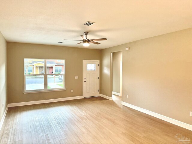 spare room featuring ceiling fan and light hardwood / wood-style flooring