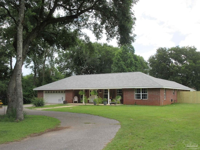 single story home featuring a garage and a front lawn