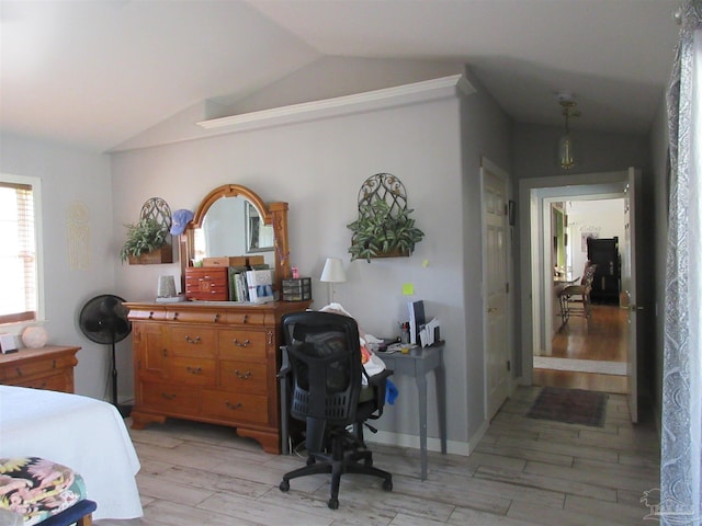 bedroom featuring vaulted ceiling and light wood-type flooring