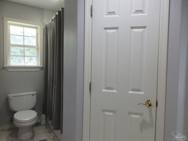 bathroom featuring a shower with curtain, tile patterned floors, and toilet