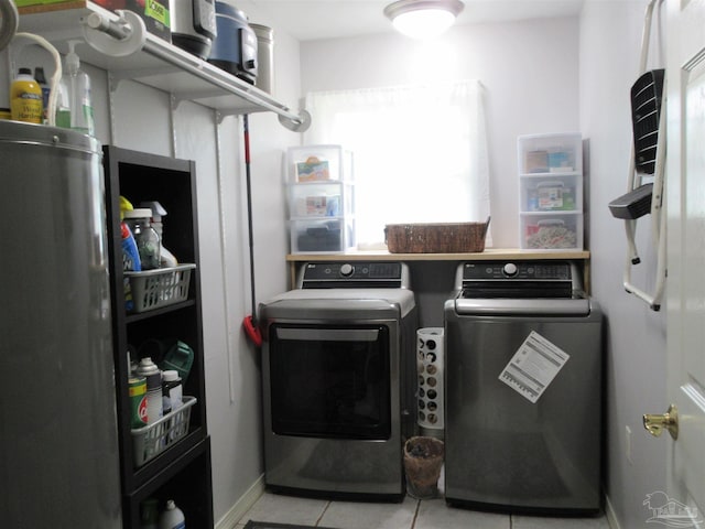 laundry area with separate washer and dryer and light tile patterned floors