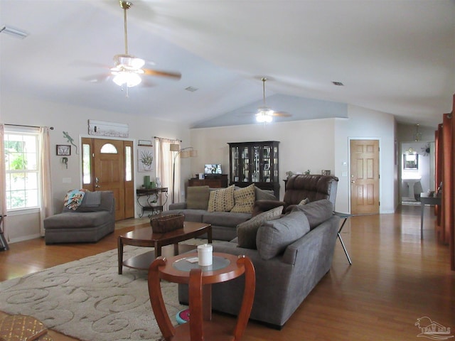 living room featuring lofted ceiling, hardwood / wood-style floors, and ceiling fan