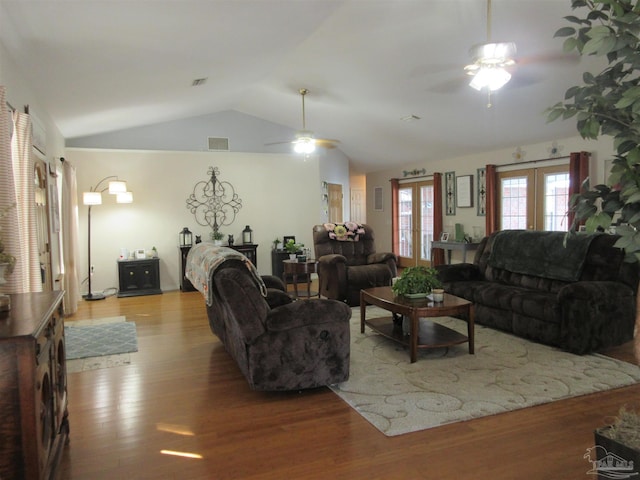 living room featuring ceiling fan, lofted ceiling, and light hardwood / wood-style flooring